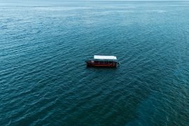a boat floating on top of a large body of water